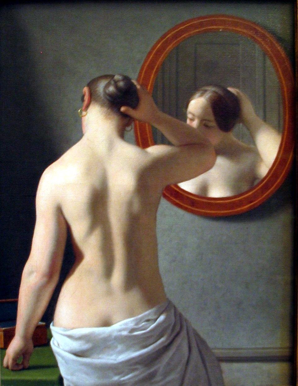 Woman-Standing-in-Front-of-a-Mirror-by-C